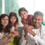 Indian family together at home, weighing a decision to move abroad