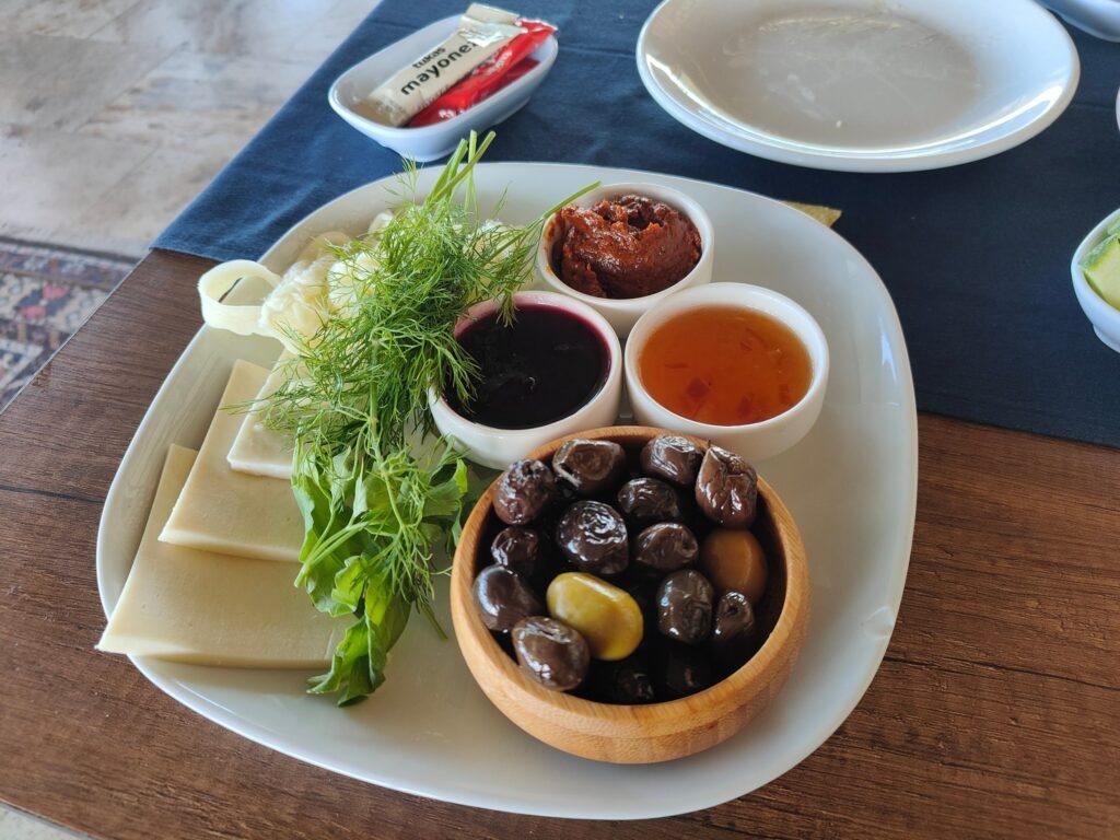 Vegetarian Turkish breakfast plate with cheese, olives, jam and honey