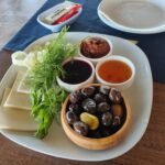 Vegetarian Turkish breakfast plate with cheese, olives, jam and honey