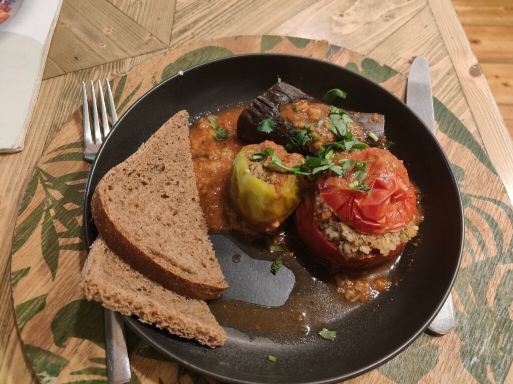 Plate of stuffed eggplant, pepper and tomato dolma at a vegan restaurant in Baku