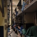 Third class open plan coach on the Tbilisi to Yerevan night train with passengers on their bunks