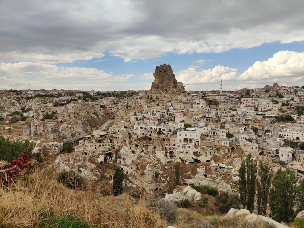 Uçhisar town in Cappadocia with the rock castle rising above houses built into the hillside