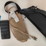 Spare phone, bank cards, a body pouch and a hip pouch laid out to protect your money abroad